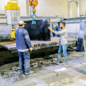 Marble factory workers with crane